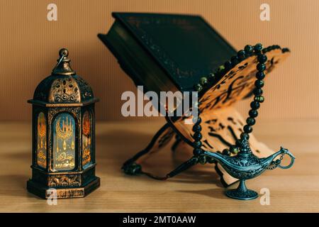 An ornamental Arabic lantern with a burning candle glowing at night Stock Photo