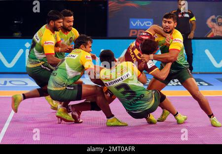 Players of Puneri Paltan pin down Monu Goyat, in green jersey, of Patna  Pirates during their Vivo Pro Kabaddi league match in Mumbai, India,  Tuesday, Oct. 24, 2017. (AP Photo/Rafiq Maqbool Stock