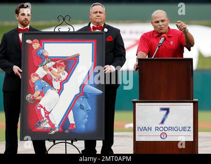 Former Texas Rangers' Ivan Rodriguez, right, looks on as former Major  League Baseball players Roberto Alomar, left, and Ferguson Jenkins, second  from left, unveil his Hall of Fame plaque during a ceremony