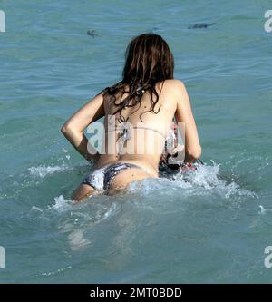 Maria Menounos finally had her way and dragged Jonathan Cheban into the ocean. Bikini clad Maria grabbed hold of the PR guru and pushed him into the waves. Miami Beach, FL. 29th December 2011. Stock Photo