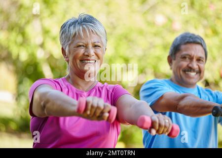Were doing our best to stay active. Portrait of a mature couple exercising together in their backyard. Stock Photo