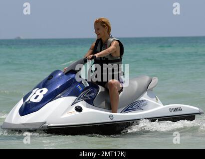 Swiss TV host and actress Michelle Hunziker spends an afternoon jetskiing with boyfriend Tomaso Trussardi during a visit to Miami Beach, FL. 4th June 2012. Stock Photo