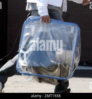 Exclusive!! Michelle Rodriguez makes her own fashion statements these days. The actress was spotted dropping off a bunch of shoes and boots at a custom design store in Hollywood, Ca. Rodriguez was also wearing a Jack Daniels bandana around her leg. 4/18/07 Stock Photo