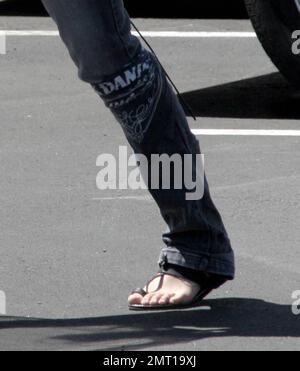 Exclusive!! Michelle Rodriguez makes her own fashion statements these days. The actress was spotted dropping off a bunch of shoes and boots at a custom design store in Hollywood, Ca. Rodriguez was also wearing a Jack Daniels bandana around her leg. 4/18/07 Stock Photo