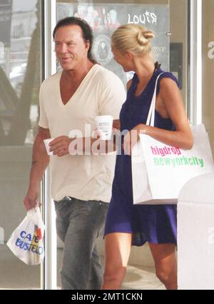 Oscar nominated actor and co-star of the upcoming 'Iron Man 2' Mickey Rourke out for a stroll along Collins Avenue with beautiful blonde girlfriend, model Anastassija Makarenko.  The couple, who looked very happy while out for some shopping, met on a photo shoot and have been dating for approximately 10 months.  Miami Beach, FL. 04/08/10. Stock Photo