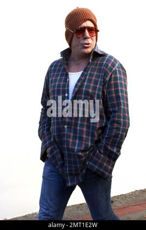 Golden Globe winner and Academy Award nominee Mickey Rourke wears an orange stocking cap and matching sunglasses paired with a plaid shirt and jeans as he leaves a local restaurant. 'The Wrestler' star will appear in 'Black November' due out later this year and 'Java Heat' due in 2013. Los Angeles, CA. 9th January 2012. Stock Photo