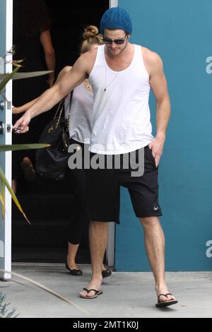 Miley Cyrus and fianc Liam Hemsworth wear workout attire as they leave their Pilates class. Los Angeles, CA. 13th July 2012.   . Stock Photo