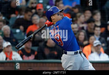 Chicago Cubs' Javier Baez, left, slides into second base safely as he hit a  one-run double as Colorado Rockies second baseman DJ LeMahieu (9) makes a  late tag during the eighth inning