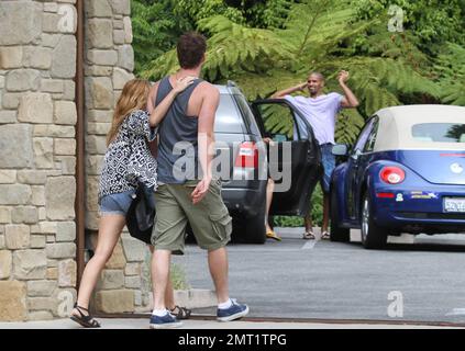 EXCLUSIVE!! Miley Cyrus and boyfriend Australian actor Liam Hemsworth take a ride around town in a convertible sports car driven by Liam before stopping at a center devoted to Meditation.  The lovey-dovey couple spent 30 minutes inside before walking out arm in arm and holding hands.  Miley, wearing jean shorts and a low cut top, tenderly kissed Liam's arm before getting back into the car and zooming off on the day of the Teen Choice awards.  Los Angeles, CA 7th August 2011 Stock Photo