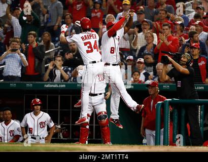 Washington Nationals Brian Goodwin (R) celebrates with Bryce Harper (L)  after hitting a solo home run against the Chicago Cubs in the ninth inning  at Wrigley Field on August 6, 2017 in