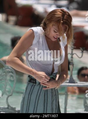 Singer Miley Cyrus spends the day with a friend floating in the pool. Miami  Beach, FL. 13th June 2012 Stock Photo - Alamy