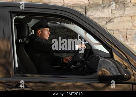 Professional driver in luxury car. Chauffeur service Stock Photo