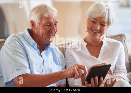We got the most likes. a senior couple using a digital tablet at home. Stock Photo