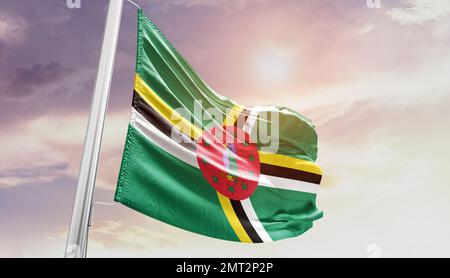 dominica waving flag in beautiful sky. Stock Photo