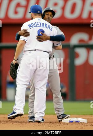 Seattle Mariners former second baseman Bret Boone, left, and former  outfielder Mike Cameron, right, stand in the dugout before throwing out  ceremonial first pitches before a baseball game between the Mariners and