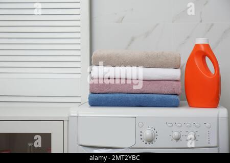 Stack of clean towels on white table in laundry room, space for text Stock  Photo - Alamy