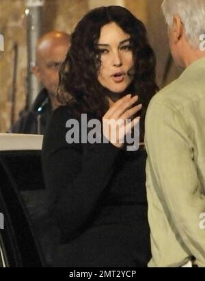 Beautiful Italian actress Monica Bellucci, 46, shows off her amazing figure in a slimming black dress on the set of the Italian romantic comedy 'Manuale d'amore 3'.  The film, a third in a series of the hit movies by Giovanni Veronesi, also stars American actor Robert De Niro.  Bellucci, who gave birth to her second child only five months ago, filmed her night scene with co-star Michele Placido.  Bellucci has two daughters, Deva and Leonie, with husband, French actor Vincent Cassel.  Rome, ITA. 10/05/10. Stock Photo