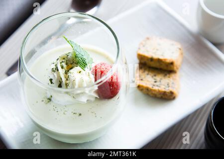 Matcha tea Japanese cheesecake with wiped cream and strawberry. Stock Photo