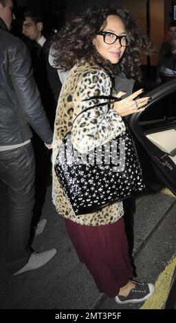 EXCLUSIVE!! Pregnant pop singer, pianist and TV personality Myleene Klass looks happy and comfy as she leaves a photo shoot late in the evening in a mismatched outfit of a burgundy maxi dress, baby-bump covering leopard patterned coat, sparkly star tote bag, nerd glasses, scarf and Converse sneakers.  The former Hear'Say singer posted to her Twitter account, 'Fun shoot..Have been back combed to within an inch of my life.' And in a later posted, 'Umƒ. anyone got any conditioner?!' London, UK. 10/07/10. Stock Photo