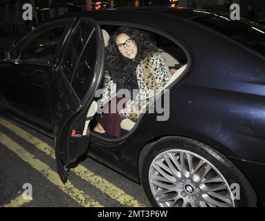 EXCLUSIVE!! Pregnant pop singer, pianist and TV personality Myleene Klass looks happy and comfy as she leaves a photo shoot late in the evening in a mismatched outfit of a burgundy maxi dress, baby-bump covering leopard patterned coat, sparkly star tote bag, nerd glasses, scarf and Converse sneakers.  The former Hear'Say singer posted to her Twitter account, 'Fun shoot..Have been back combed to within an inch of my life.' And in a later posted, 'Um. anyone got any conditioner?!' London, UK. 10/07/10. Stock Photo