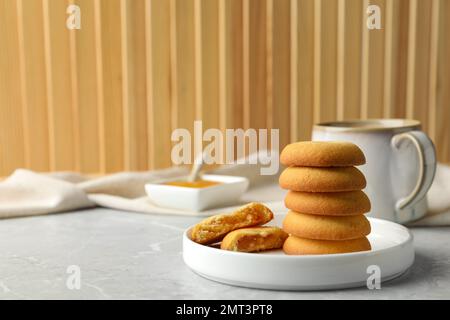 Tasty shortbread cookies with filling on light grey marble table Stock Photo