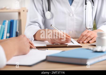 Doctors working at desk in office, closeup. Medical service Stock Photo