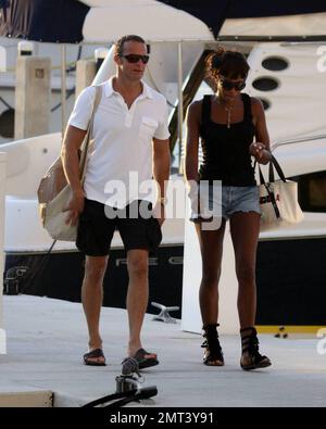 EXCLUSIVE!! Naomi Campbell and her Russian boyfriend Vladislav Doronin live the life of luxury cruising the water around Miami on a $10,950,000 Lazzara yacht. The couple passed the huge mansion they have reportedly purchased on Star Island for $16,000,000 as they went. The Supermodel lounged in a chair on the top of the double decker Angela D during the sunset ride home with her hunky beau but stood up to view their new home as they floated by. Miami, FL. 10/11/09. Stock Photo