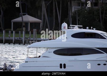 EXCLUSIVE!! Naomi Campbell and her Russian boyfriend Vladislav Doronin live the life of luxury cruising the water around Miami on a $10,950,000 Lazzara yacht. The couple passed the huge mansion they have reportedly purchased on Star Island for $16,000,000 as they went. The Supermodel lounged in a chair on the top of the double decker Angela D during the sunset ride home with her hunky beau but stood up to view their new home as they floated by. Miami, FL. 10/11/09. Stock Photo