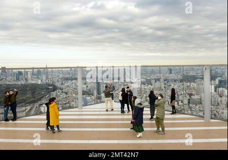 Tourist enjoying the views from the Shibuya Sky roof on top of the Scramble Square building in Shibuya, Tokyo, Japan. Stock Photo