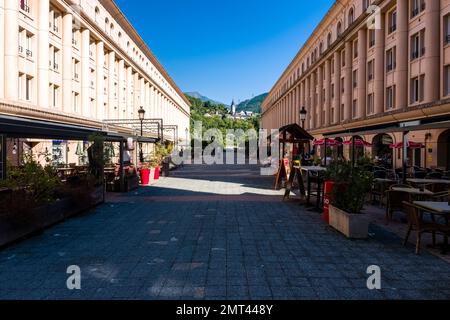 Shopping street Place de l'Europe in Albertville with outdoor restaurants and the church Église Notre-Dame-de-l'Assomption on a hill in the distance. Stock Photo