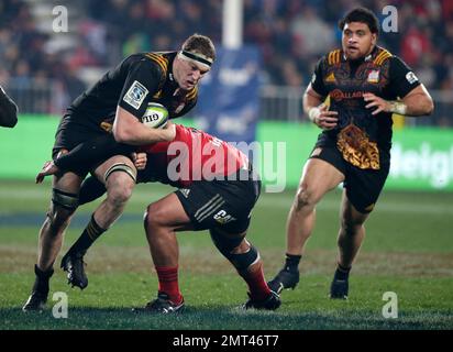 Chiefs Brodie Retallick is tackled by Crusaders Michael Alaalatoa