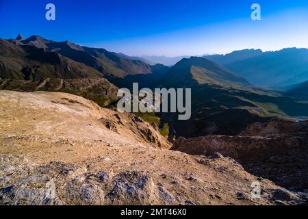 High alpine landscape with craters, mountains and ridges of the French Dauphiné Alps in the distance, seen from the pass Col du Galibier. Stock Photo