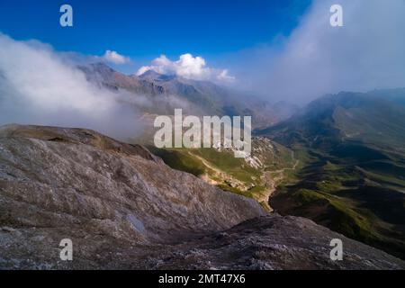 High alpine landscape with craters, mountains and ridges of the French Dauphiné Alps in the distance, seen from the pass Col du Galibier. Stock Photo