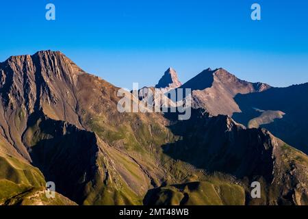 High alpine landscape with craters, mountains and ridges of the French Dauphiné Alps in the distance, seen from the pass Col du Galibier. Stock Photo