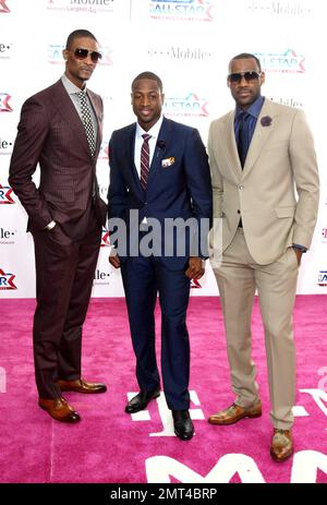 NBA players Chris Bosh, Dwyane Wade and LeBron James of the Miami Heat pose for photographers on the pink carpet ahead of the 2011 NBA All-Star game held at the Staples Center which saw West win 148-143 over the East. Los Angeles, CA. 02/20/11. Stock Photo