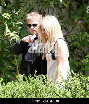 Exclusive!! Avril Lavigne and Deryck Whibley leave a trendy Los Angeles hotel. Avril is not wearing her wedding ring. The woman in the photo could be her mother. 8/4/06 All Stock Photo
