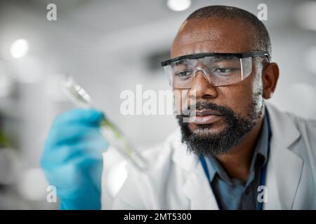 Scientist face, thinking and test tubes in laboratory pharma, medical science research or gmo food engineering. Zoom, man and biologist with glass Stock Photo