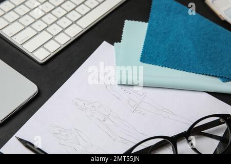 Composition with sketches and accessories on black stone table, closeup. Designer's workplace Stock Photo