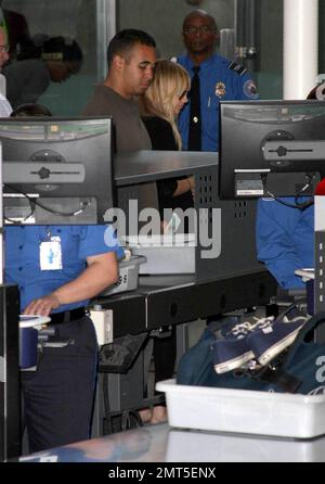 A pregnant Nicole Richie, Joel Madden and daughter Harlow were seen arriving at LAX for a flight out of town this afternoon.  Joel and Harlow entered the terminal first followed by Nicole, who seemed to have a flip-flop malfunction upon exiting her car.  Los Angeles, CA.  5/4/09. Stock Photo