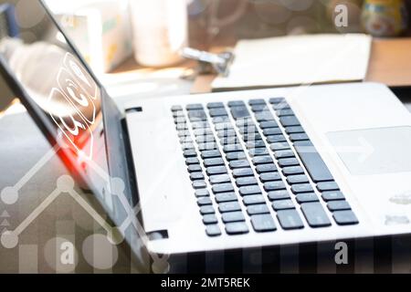 Notebook with business work Hand using a laptop and touching on virtual screen contact icons, email and address, live chat with internet wifi. Stock Photo