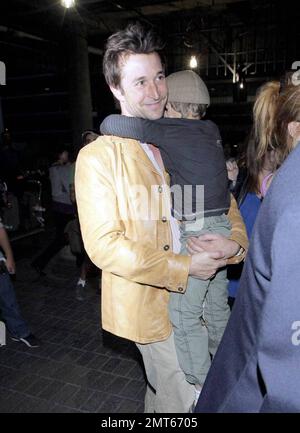 'ER' star Noah Wylie and family arrive stateside at Los Angeles International Airport after a family European vacation. Noah and his wife Tracy Warbin, carried thier children, daughter Auden and son Owen Strausser through the airport as they were assisted with their luggage. The kids looked tired after the long flight. Los Angeles, CA. 4/29/09.   . Stock Photo