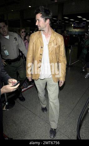 'ER' star Noah Wylie and family arrive stateside at Los Angeles International Airport after a family European vacation. Noah and his wife Tracy Warbin, carried thier children, daughter Auden and son Owen Strausser through the airport as they were assisted with their luggage. The kids looked tired after the long flight. Los Angeles, CA. 4/29/09. Stock Photo