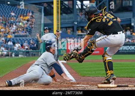Milwaukee Brewers' Travis Shaw slides safely under the swipe tag by  Pittsburgh Pirates catcher Francisco Cervelli during the fourth inning of a  baseball game in Pittsburgh, Monday, July 17, 2017. Shaw scored