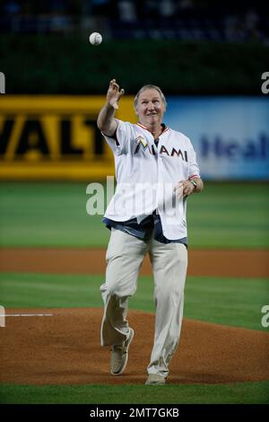 Former Florida Marlins Charlie Hough, left, and Benito Santiago, of Puerto  Rico, congratulate each other after Hough threw a ceremonial first pitch to  Santiago before the start of a baseball game between