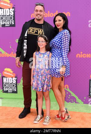 Derek Wolfe, Abigail Burrows and Tatum Burrows attending the