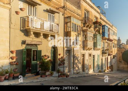 Colorful traditional Maltese balconies in Valletta. Street at sunny day Stock Photo