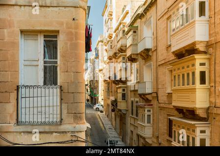 Colorful traditional Maltese balconies in Valletta. Street at sunny day Stock Photo