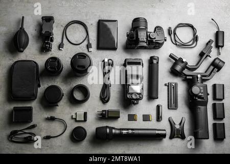 Flat lay composition with camera and video production equipment on light grey stone background Stock Photo