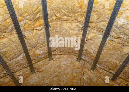 Aluminum frame with hangers placed on beams in the attic for mounting plasterboards. Stock Photo