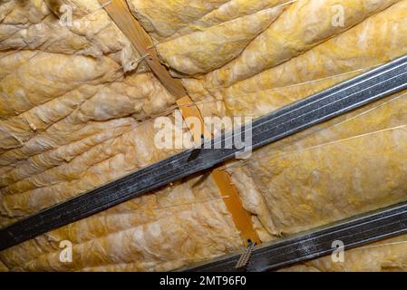 Aluminum frame with hangers placed on beams in the attic for mounting plasterboards. Stock Photo